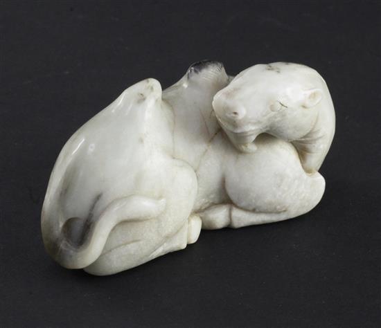 A Chinese white and black jade carving of a recumbent Bactrian camel, in Song dynasty style, 8.5cm